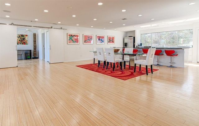 9707 Timber Ridge Pass, Austin, TX 78733 - dining area featuring light wood finished floors and recessed lighting