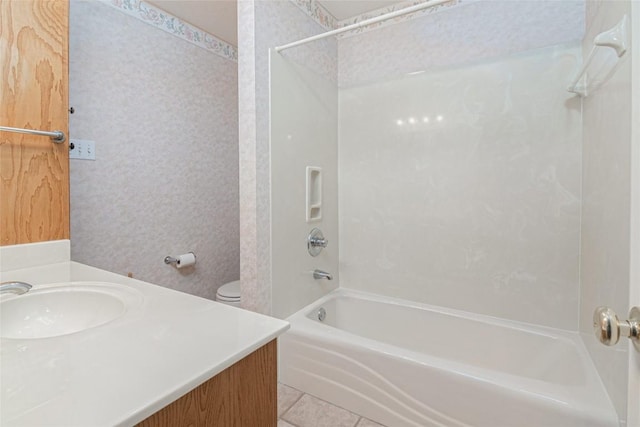 668 Sagewood Pkwy, Seguin, TX 78155 - bathroom with vanity, bathtub / shower combination, tile patterned flooring, wallpapered walls, and toilet