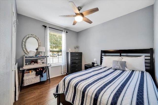 bedroom with baseboards, a ceiling fan, and wood finished floors