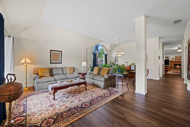 living area featuring dark wood-style flooring, visible vents, a notable chandelier, and lofted ceiling