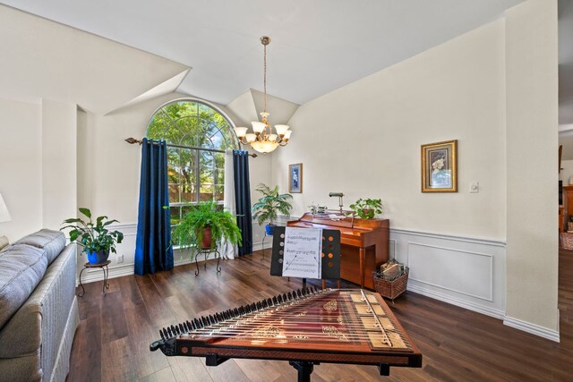 office space featuring a chandelier, vaulted ceiling, a wainscoted wall, and wood finished floors