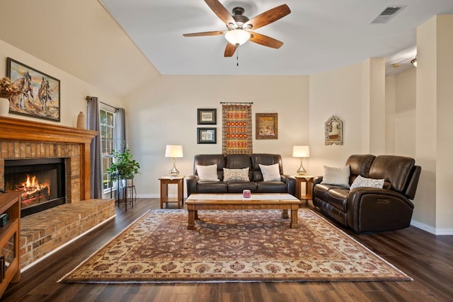 living area featuring baseboards, ceiling fan, a fireplace, and visible vents