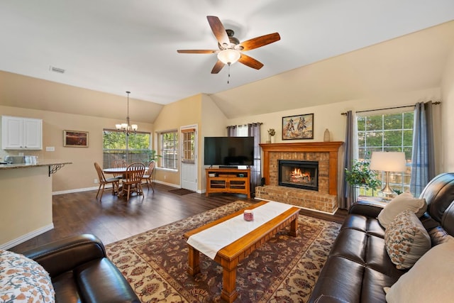living room with visible vents, baseboards, plenty of natural light, and lofted ceiling