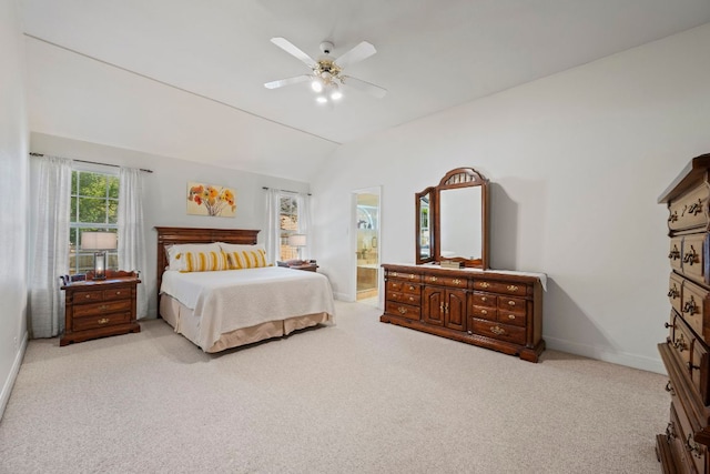 carpeted bedroom with baseboards, ceiling fan, and lofted ceiling