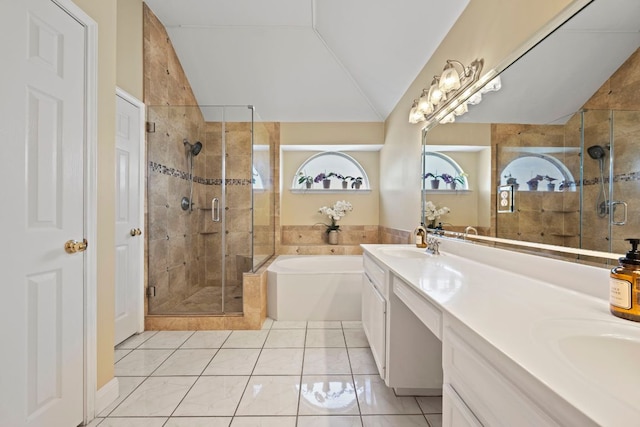 bathroom featuring a bath, a sink, vaulted ceiling, and plenty of natural light