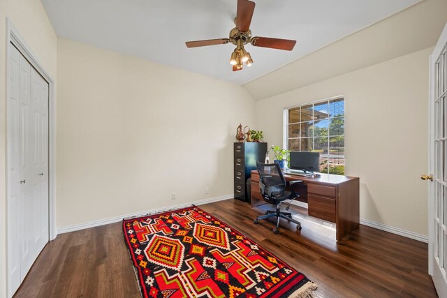 office space with baseboards, ceiling fan, lofted ceiling, and dark wood-style floors