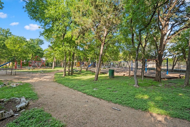 surrounding community with a yard and playground community