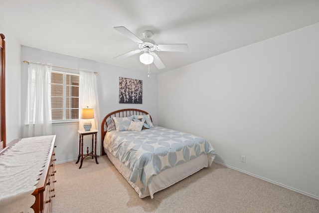 carpeted bedroom featuring ceiling fan and baseboards