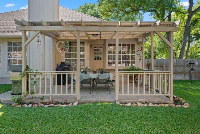rear view of property featuring a pergola, fence, a lawn, and roof with shingles
