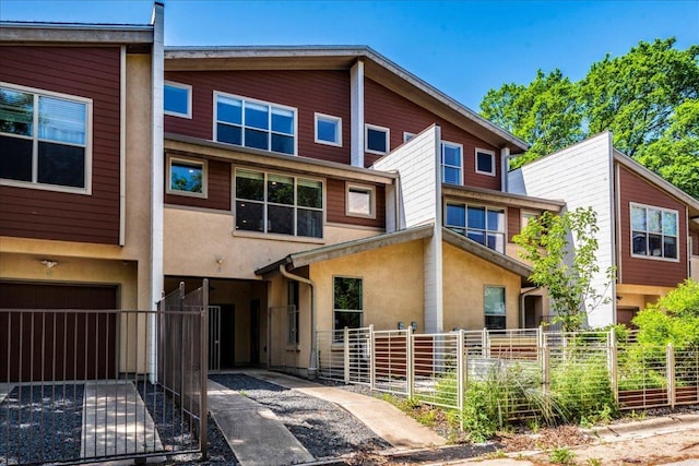 2608 E 6th St Unit 6, Austin, TX 78702 - view of property with a gate, stucco siding, and fence