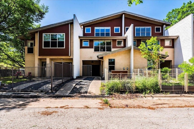 2608 E 6th St Unit 6, Austin, TX 78702 - multi unit property featuring stucco siding, a gate, and a fenced front yard