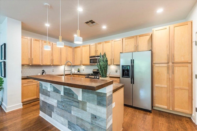 2608 E 6th St Unit 6, Austin, TX 78702 - kitchen featuring visible vents, appliances with stainless steel finishes, light brown cabinets, and dark wood-style floors