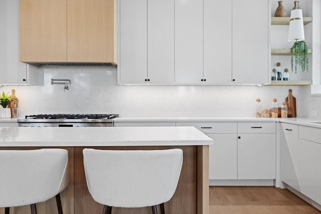3412 Rosefinch Trl, Austin, TX 78746 - kitchen with open shelves, light countertops, and a kitchen breakfast bar