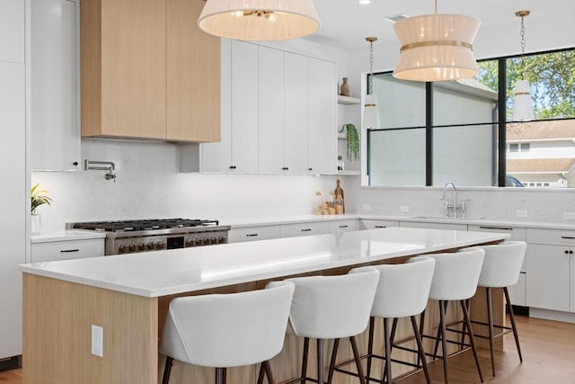 3412 Rosefinch Trl, Austin, TX 78746 - kitchen with a center island, backsplash, and a kitchen breakfast bar