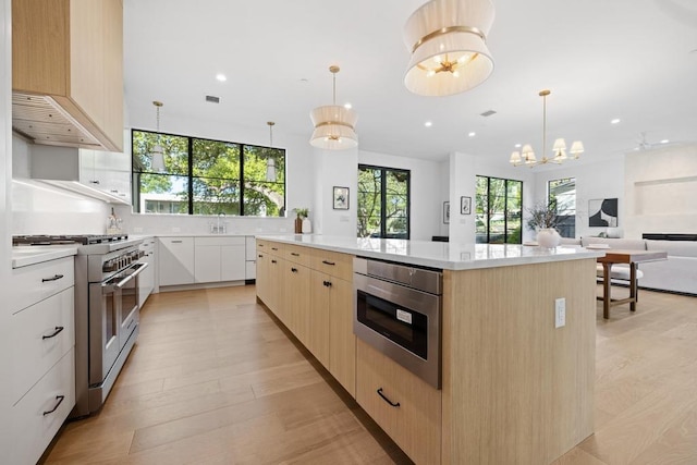 3412 Rosefinch Trl, Austin, TX 78746 - kitchen with high end stainless steel range oven, light brown cabinetry, light countertops, modern cabinets, and recessed lighting