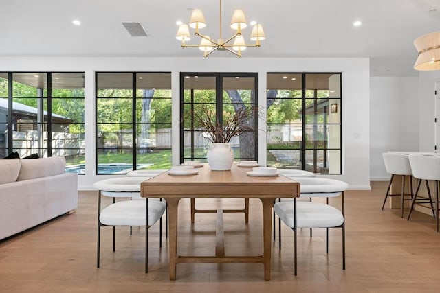 3412 Rosefinch Trl, Austin, TX 78746 - dining room featuring a chandelier, light wood finished floors, healthy amount of natural light, and recessed lighting