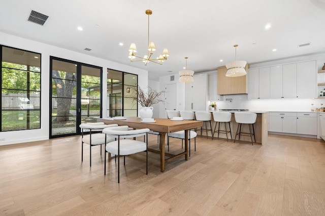 3412 Rosefinch Trl, Austin, TX 78746 - dining area with light wood-style floors, a chandelier, and recessed lighting