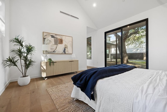 3412 Rosefinch Trl, Austin, TX 78746 - bedroom with access to outside, light wood finished floors, high vaulted ceiling, and recessed lighting