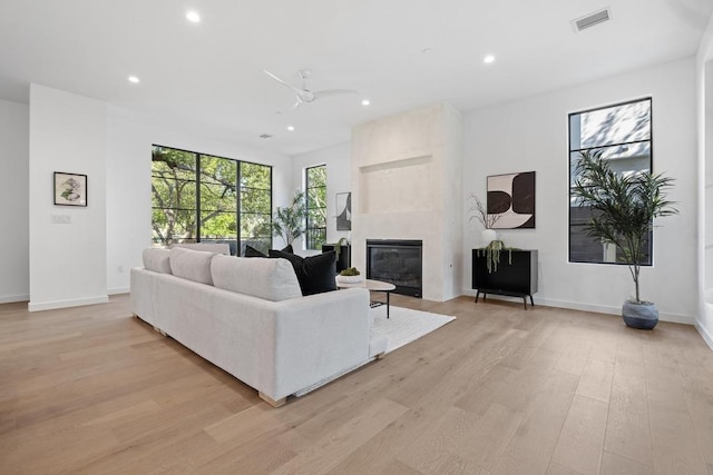 3412 Rosefinch Trl, Austin, TX 78746 - living room featuring light wood finished floors, a fireplace, recessed lighting, and ceiling fan