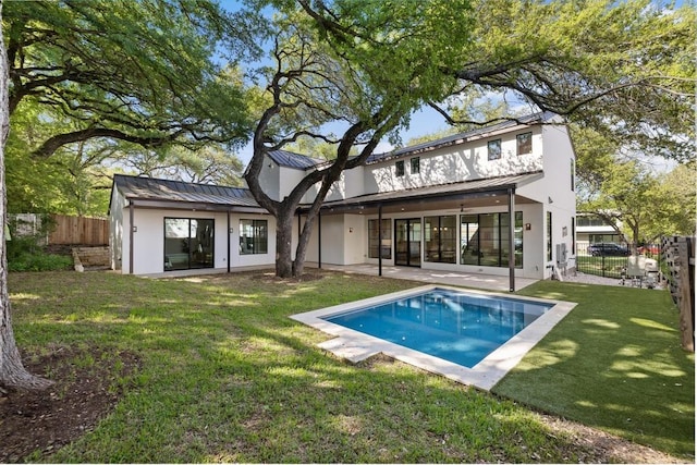 3412 Rosefinch Trl, Austin, TX 78746 - rear view of house with stucco siding, a standing seam roof, a fenced backyard, and a patio