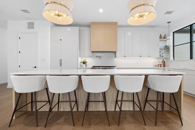 3412 Rosefinch Trl, Austin, TX 78746 - kitchen featuring backsplash, light countertops, light wood finished floors, open shelves, and recessed lighting