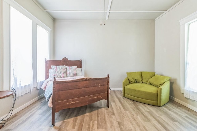 1132 W Clark St, Bartlett, TX 76511 - bedroom featuring light wood-style flooring, multiple windows, and baseboards