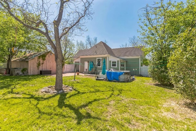1132 W Clark St, Bartlett, TX 76511 - back of property featuring an outdoor structure and a shingled roof