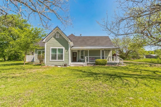 1132 W Clark St, Bartlett, TX 76511 - back of property featuring covered porch, a shingled roof, and a lawn