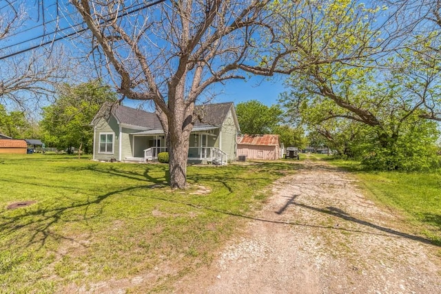 1132 W Clark St, Bartlett, TX 76511 - view of front of house featuring a front lawn and a sunroom