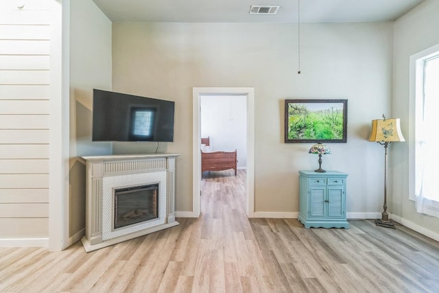 1132 W Clark St, Bartlett, TX 76511 - living room with wood finished floors, baseboards, and a glass covered fireplace
