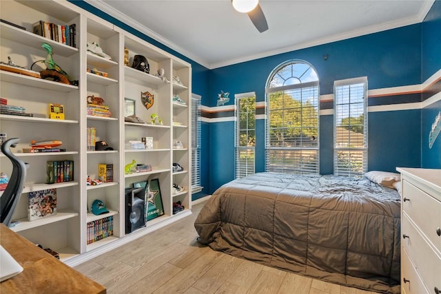 bedroom with wood finished floors, ornamental molding, and ceiling fan