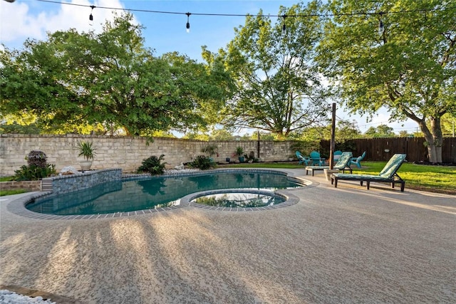view of swimming pool featuring a fenced backyard, a patio area, and a pool with connected hot tub
