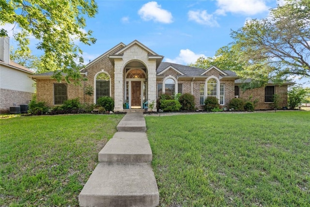 11800 Yarbrough Dr, Austin, TX 78748 - view of front facade with a front lawn, brick siding, and stone siding