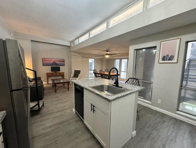 5918 Lago Vista Way Unit D32, Leander, TX 78645 - kitchen with freestanding refrigerator, a sink, black dishwasher, and dark wood-type flooring