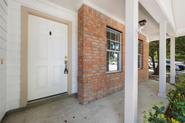18513 Silent Water Way, Pflugerville, TX 78660 - doorway to property featuring covered porch and brick siding