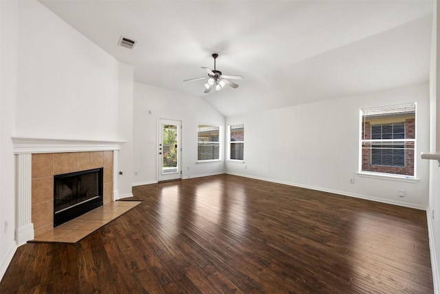 18513 Silent Water Way, Pflugerville, TX 78660 - unfurnished living room with ceiling fan, vaulted ceiling, a tiled fireplace, and wood finished floors