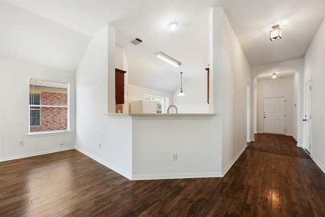 18513 Silent Water Way, Pflugerville, TX 78660 - hall with arched walkways, dark wood finished floors, and vaulted ceiling