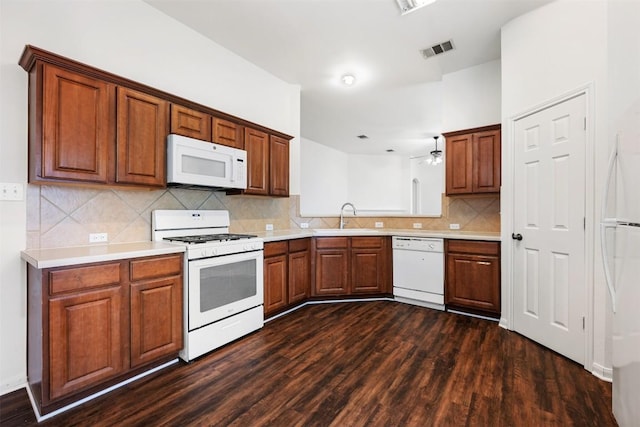 18513 Silent Water Way, Pflugerville, TX 78660 - kitchen with white appliances, dark wood finished floors, ceiling fan, and tasteful backsplash
