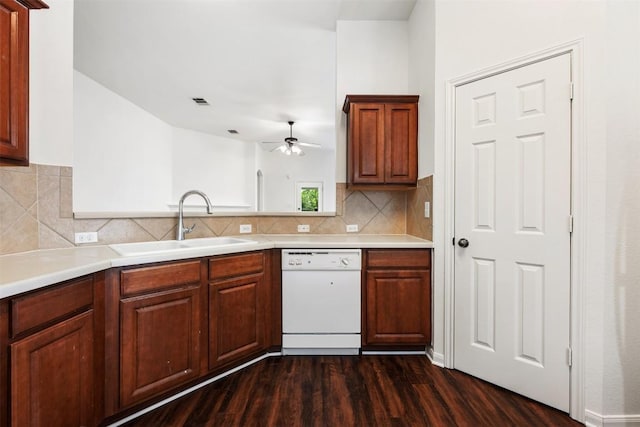 18513 Silent Water Way, Pflugerville, TX 78660 - kitchen with dishwasher, dark wood-style floors, a ceiling fan, backsplash, and light countertops