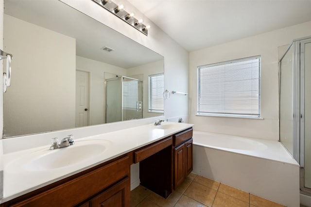 18513 Silent Water Way, Pflugerville, TX 78660 - bathroom with double vanity, a shower stall, a bath, and tile patterned floors