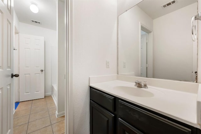 18513 Silent Water Way, Pflugerville, TX 78660 - bathroom with vanity, tile patterned floors, and a tub