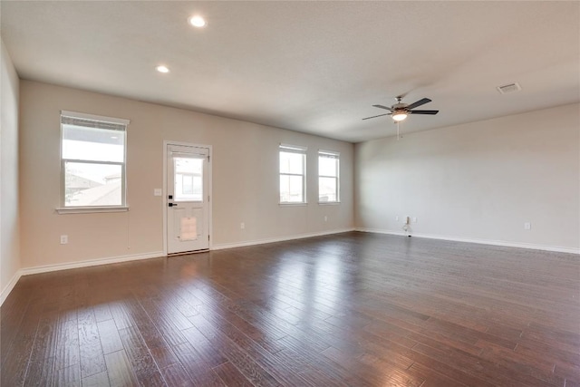 unfurnished living room with ceiling fan, recessed lighting, baseboards, dark wood-type flooring, and visible vents