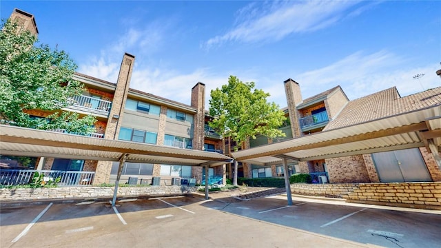 view of building exterior with covered parking