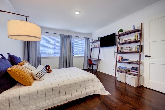 bedroom with recessed lighting, baseboards, crown molding, and wood finished floors
