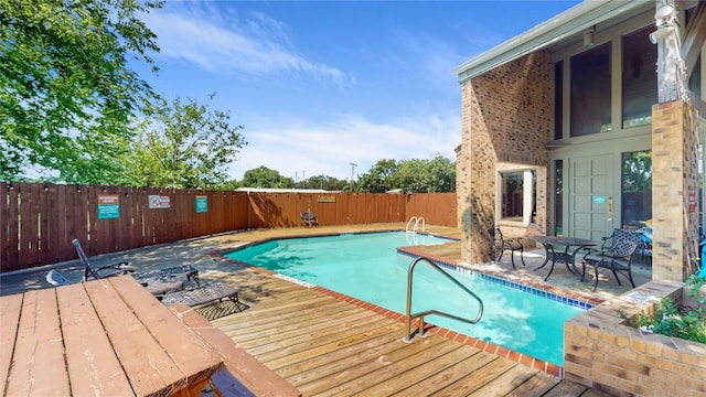 view of pool featuring a fenced in pool, a deck, and fence