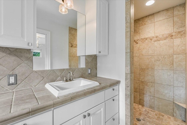 201 Westwood Ter, West Lake Hills, TX 78746 - full bathroom with a tile shower, vanity, and decorative backsplash