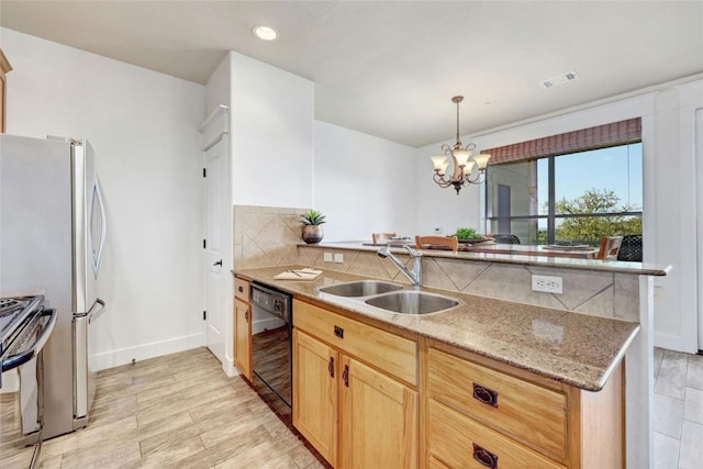 17808 Maritime Dr Unit 202, Jonestown, TX 78645 - kitchen featuring appliances with stainless steel finishes, tasteful backsplash, a peninsula, a chandelier, and light brown cabinets