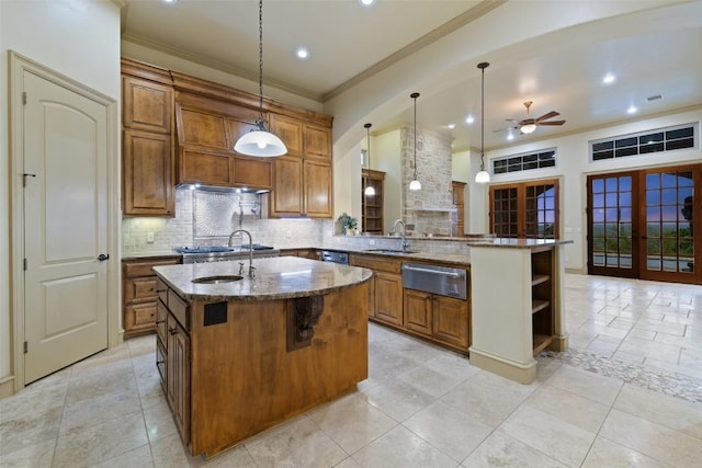 11913 Preserve Vista Ter, Austin, TX 78738 - kitchen with a warming drawer, a sink, brown cabinets, stone counters, and decorative backsplash