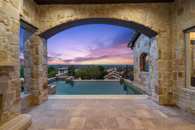 11913 Preserve Vista Ter, Austin, TX 78738 - pool at dusk with an outdoor pool and a patio area