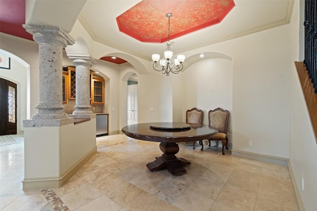 11913 Preserve Vista Ter, Austin, TX 78738 - dining area with arched walkways, ornamental molding, ornate columns, a raised ceiling, and baseboards